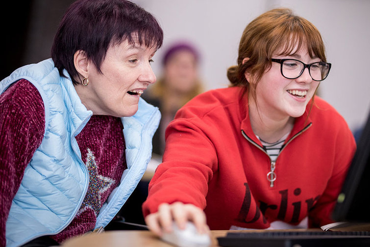 A student working with a Straight Talking Group member.