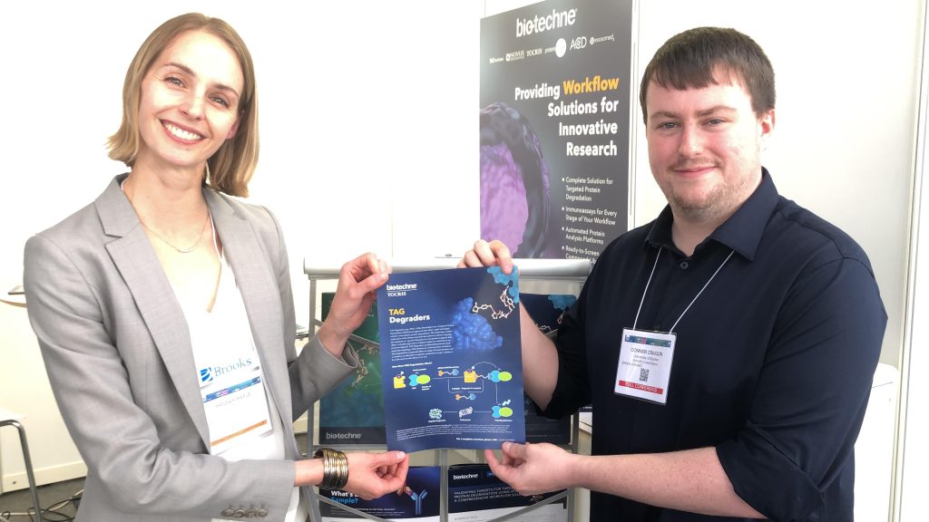 Hannah and Connor holding a Bio-Techne poster