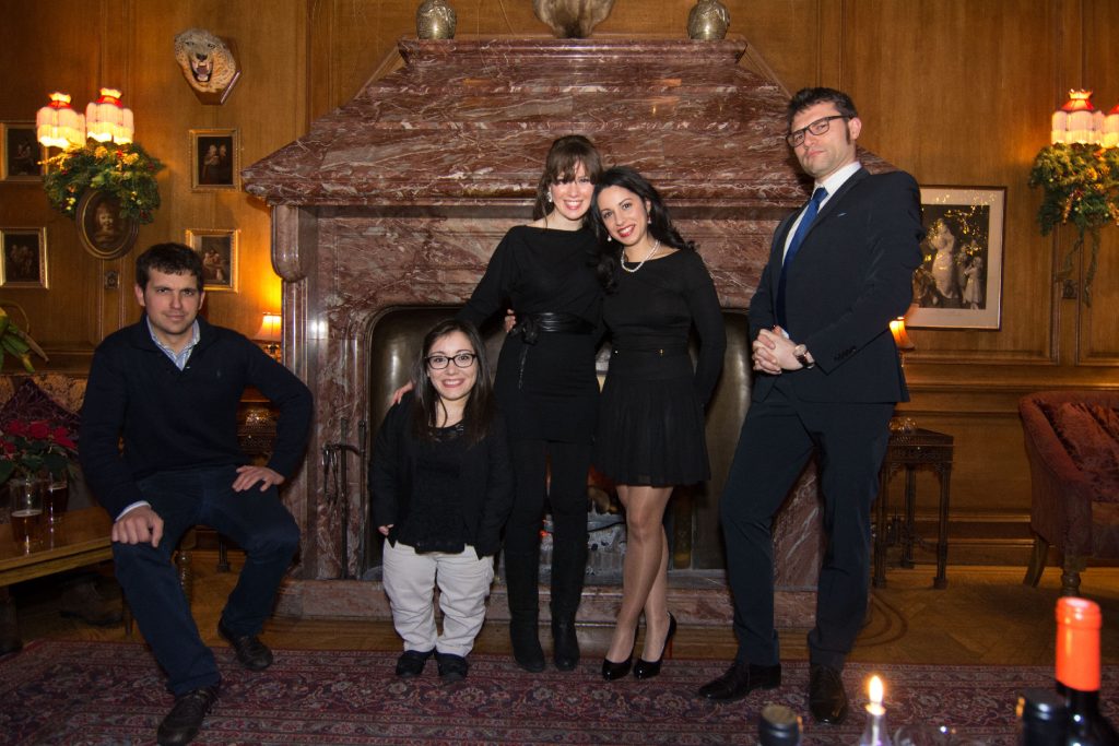 Alessio standing with a small group at Christmas party 2014