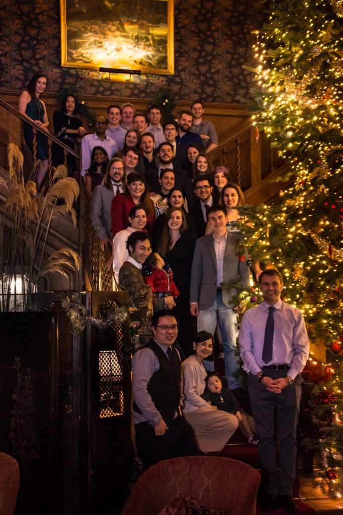 Group photo on staircase with Christmas tree