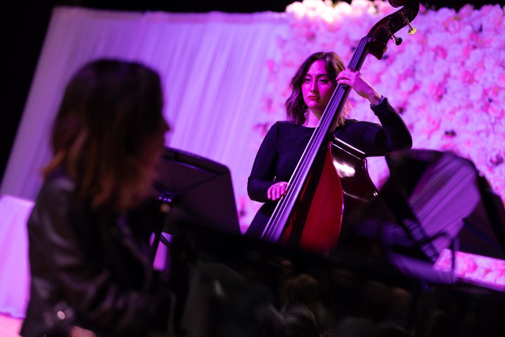 A double bassist, part of the three-piece band.