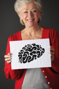 Senior woman holding ink drawing of brain