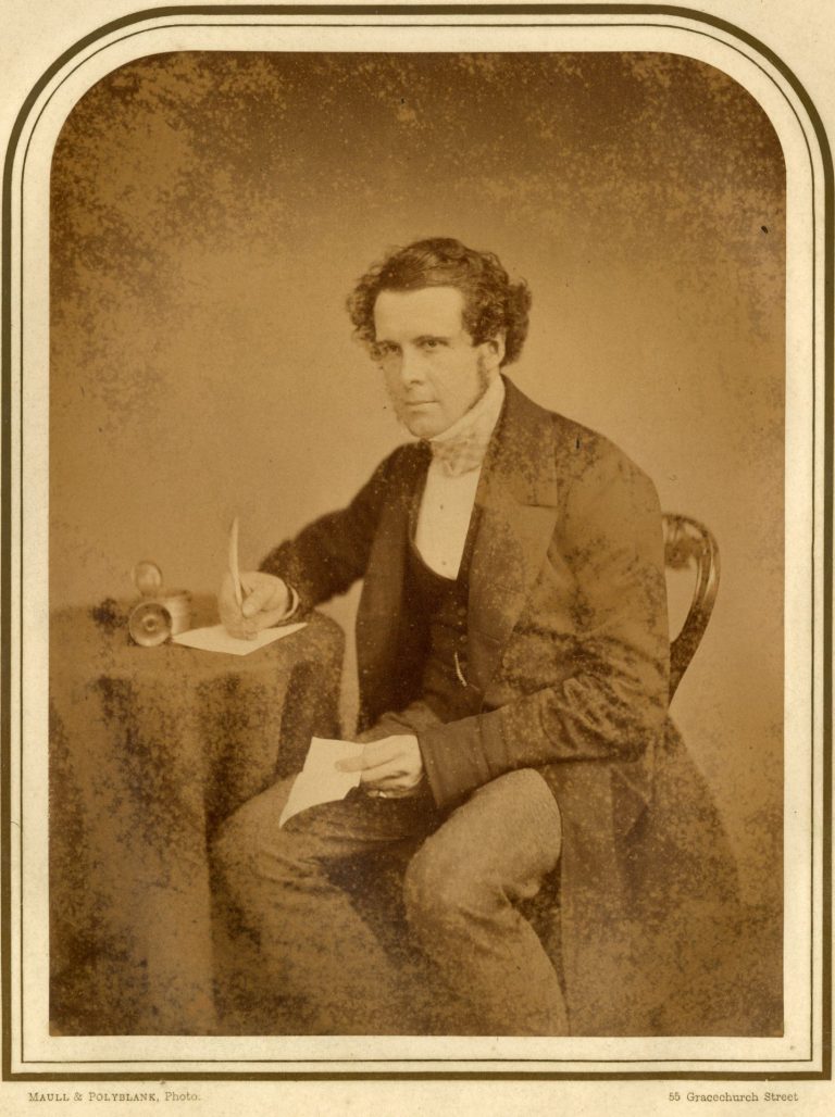 A J Halley writing at desk