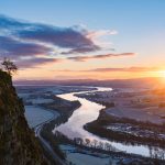 Hill, river and sunset