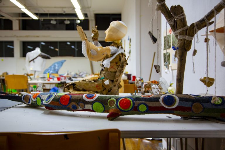 Student project work on table, painted tree and handmade mannequin