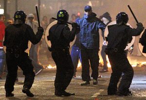 Riot police confronting by rioters in 2011 riots in England