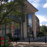 Main library in the sunshine with recycling bins outside