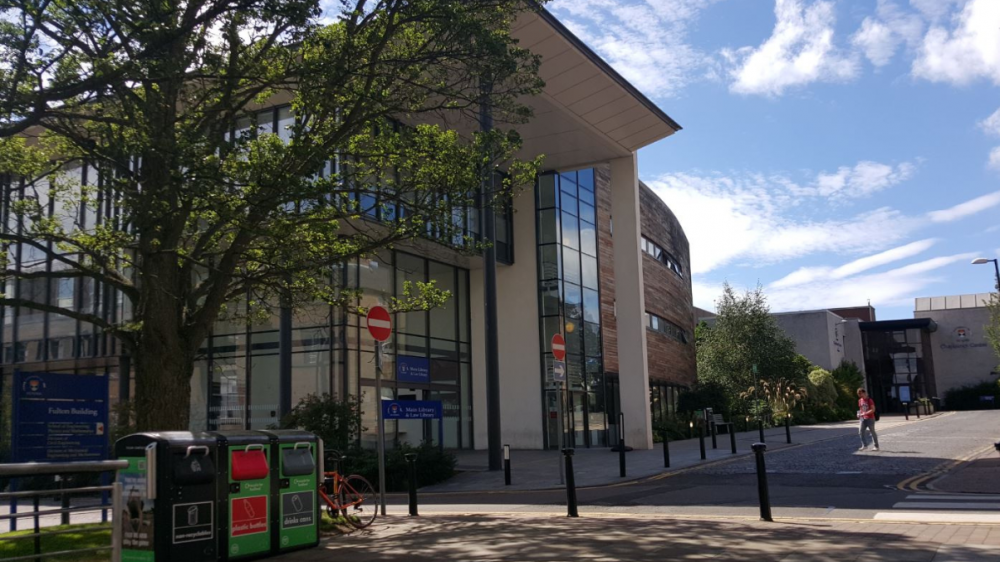 Main library in the sunshine with recycling bins outside