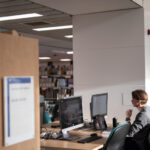 Student studying at a computer on the second floor of the Main Library