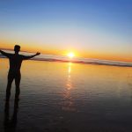 Person on beach at sunset