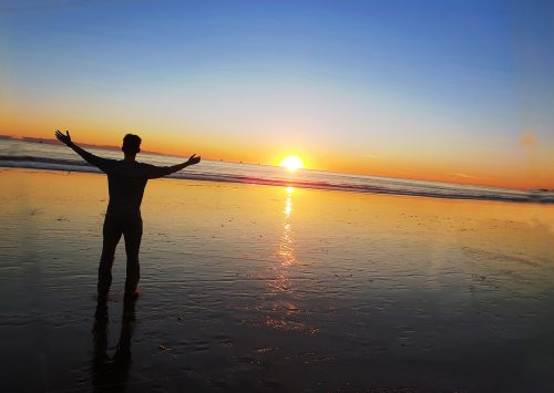 Person on beach at sunset