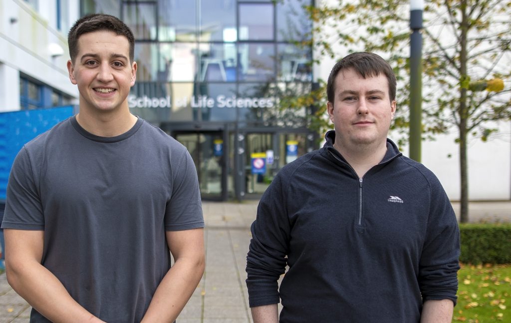 Adam and Conner in front of School of Life Sciences building