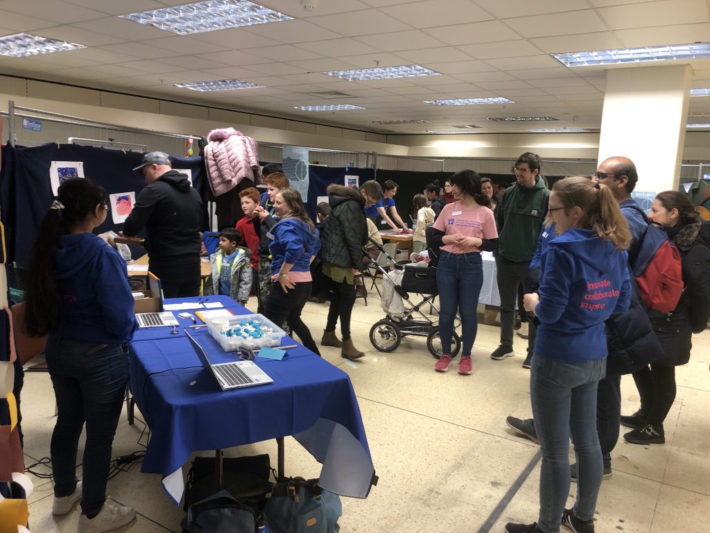 Family and staff going around venue at outreach event