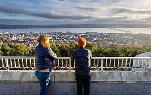 Two students looking over Dundee from The Law